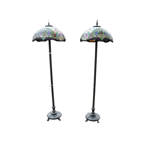 102 - Pair of Art Nouveau Tiffany Style standard lamps with leaded flora design shades. 160cm in Height by... 