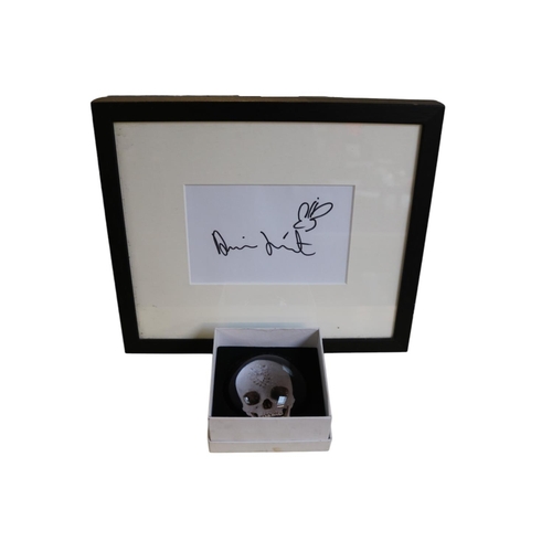 133 - Damien Hirst b.1965 Signature on paper framed and a boxed Paperweight For the Love of God