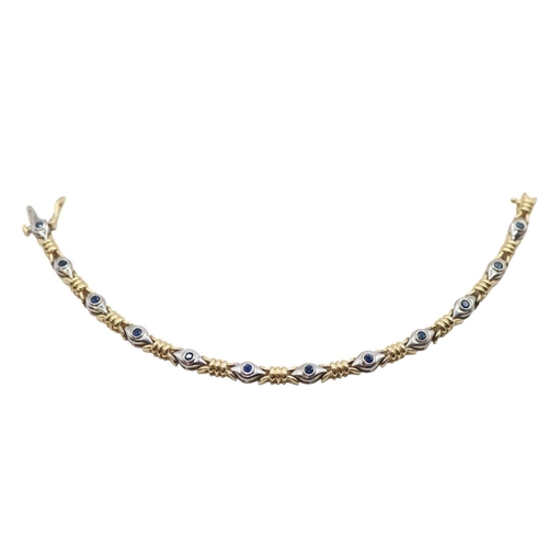 169 - Ladies 14ct Gold Sapphire set bracelet of 12 Rub over set stones in white gold with Yellow gold knot... 