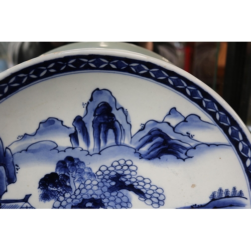 62 - Large Japanese blue and white charger decorated with rocky outcrop and Prunus tree. 37cm in Diameter