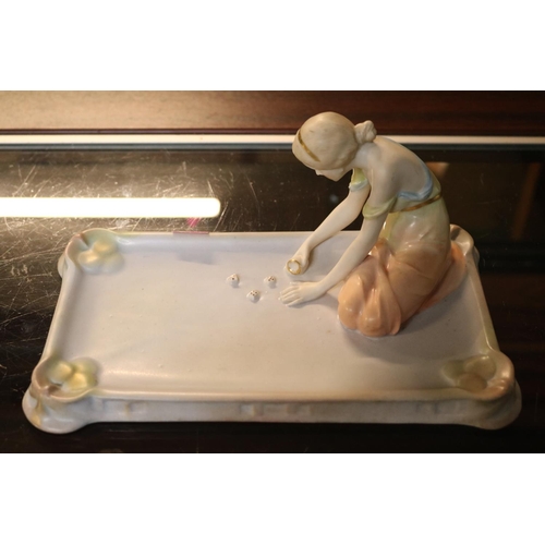 83 - Austrian Porcelain figure of a young woman playing dice on rectangular base with impressed mark to b... 