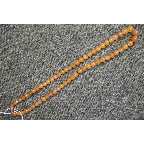 297 - Early 20thC Graduated Agate Bead necklace with yellow metal clasp. 75cm in Length