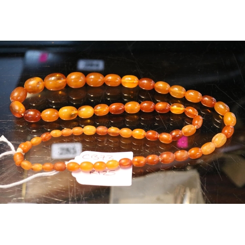 363 - Antique Graduated Amber oval Bed Necklace. 68cm in Length