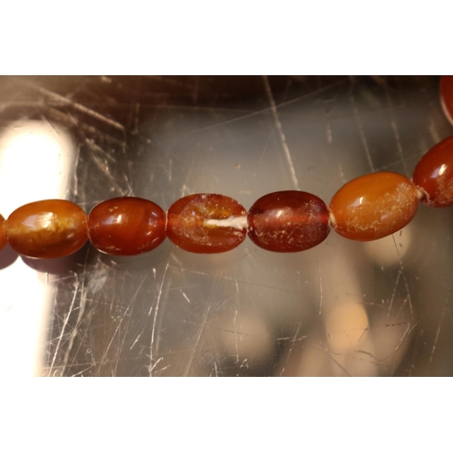 363 - Antique Graduated Amber oval Bed Necklace. 68cm in Length