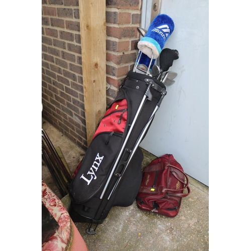 598 - Lynx Golf Caddy with assorted Golf Clubs and a Set of Lawn Bowles