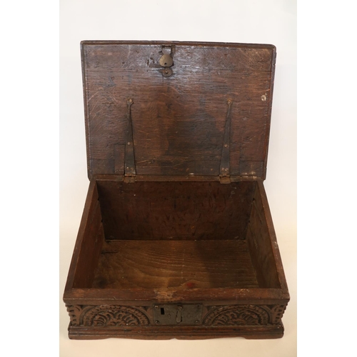 178 - A Georgian oak bible box, early 18th century, the sloped hinged lid above floral guilloche carved fr... 