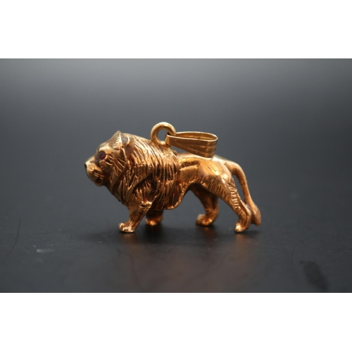 352 - Heavy 9ct Gold Lion Pendant with  Rose Cut Ruby eyes and hanging bale. Stamped 375 Hallmark to base.... 