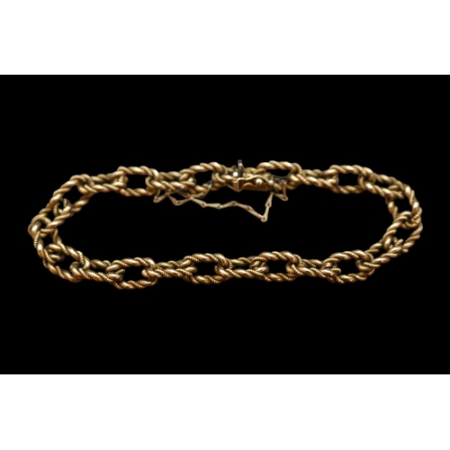 356 - 9ct Gold Fancy Link Ladies Chain bracelet of intertwined design with safety chain and push clasp. 19... 