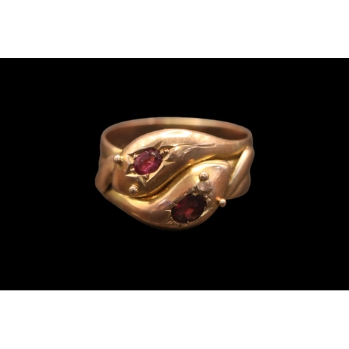 361 - A Victorian double serpent head 9ct gold and Ruby ring. Set with two Oval facetted Rubies estimated ... 