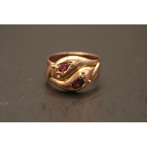 361 - A Victorian double serpent head 9ct gold and Ruby ring. Set with two Oval facetted Rubies estimated ... 