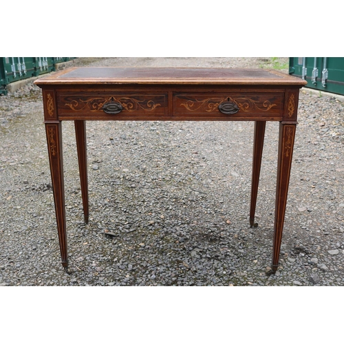 424 - Edwardian Rosewood veneered two drawer desk on tapering legs and brass caster feet. 89cm in Width