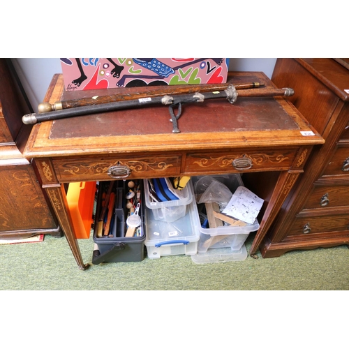 458 - Edwardian Rosewood veneered two drawer desk on tapering legs and brass caster feet. 89cm in Width