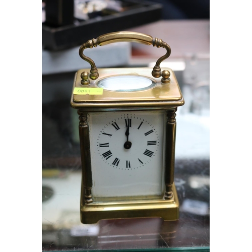 71 - Antique Brass Carriage clock  with roman numeral dial complete with key. 15cm in Height