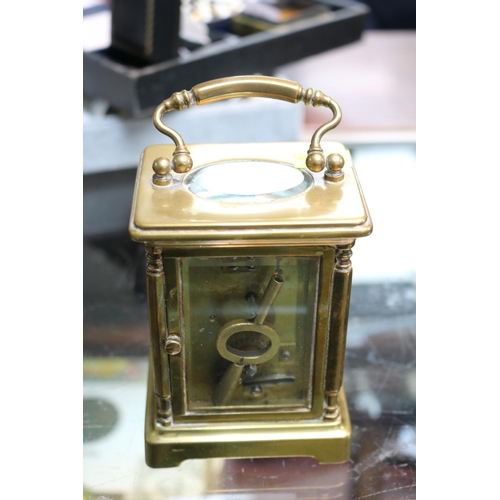 71 - Antique Brass Carriage clock  with roman numeral dial complete with key. 15cm in Height