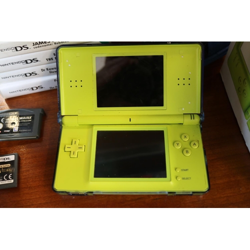 305 - Nintendo DS Lite with box and assorted games to include, Star Wars Force Unleashed, Super Mari Bros,... 