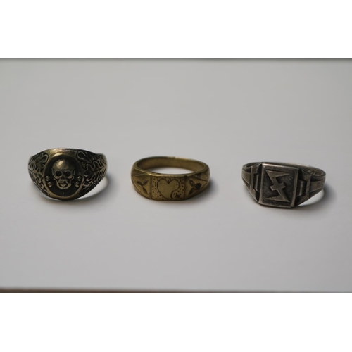 389 - A 1943 dated ring possibly military, a Skull ring and a yellow metal trench art example