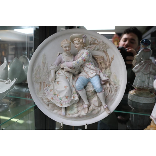 39 - Bisque 19thC Porcelain roundel depicting a courting Couple