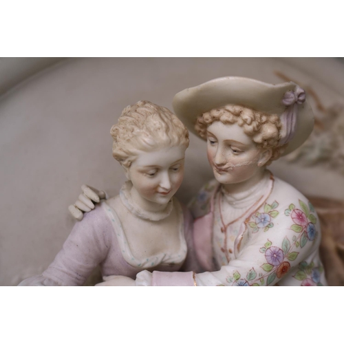 39 - Bisque 19thC Porcelain roundel depicting a courting Couple