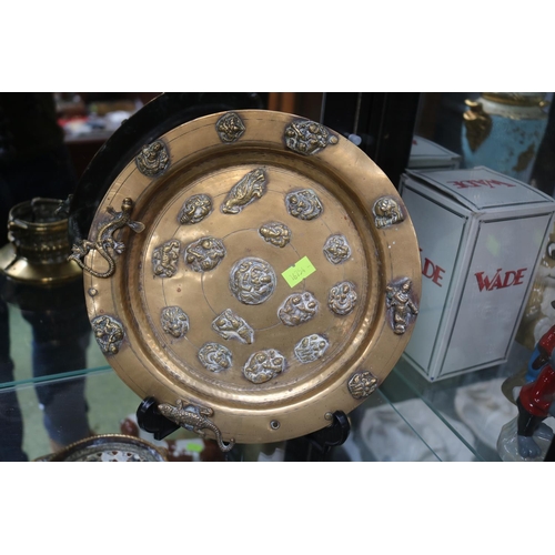 17 - Asian Brass plate decorated with Repousse lizards, Animals and Deities. 22cm in Diameter