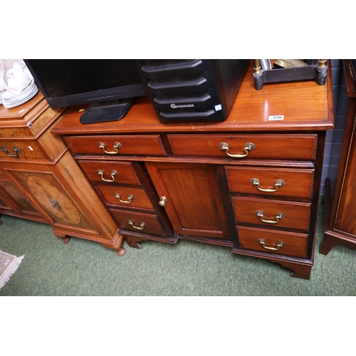 556 - Edwardian Oak desk of 8 drawers with cupboard and brass drop handles