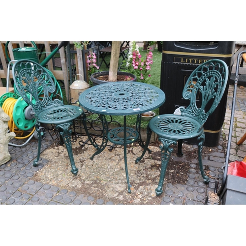 586 - Green painted Metal pierced garden table and 2 chairs