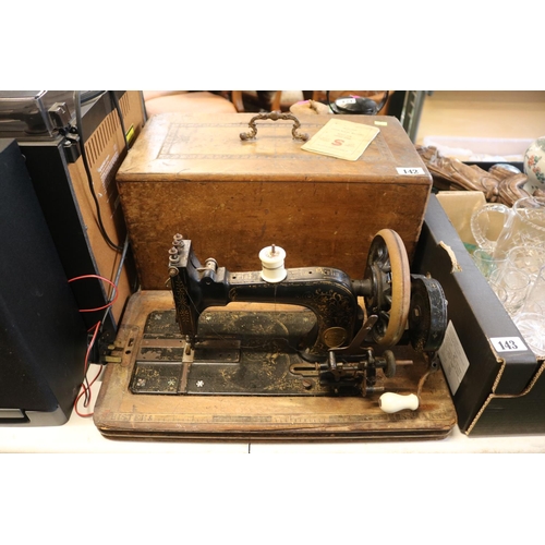 142 - Walnut Cased Frister & Rossman Sewing machine with Inlaid detail and Instruction manual