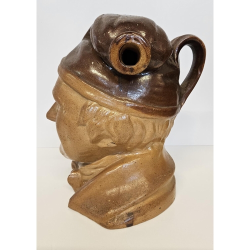 10 - Very large 19th C salt-glazed brown stoneware spirit flask of Souter Johnny. Wearing a smokers hat w... 