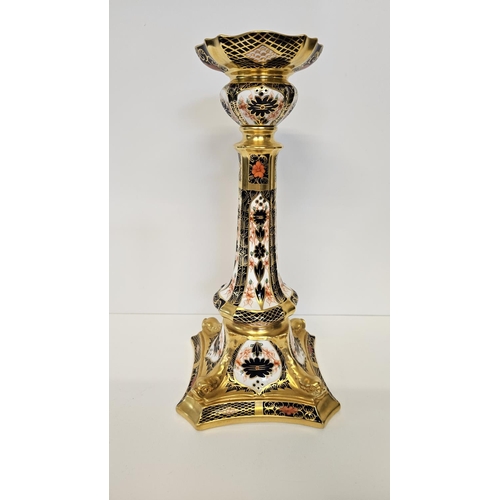 15 - A Pair of Royal Crown Derby Table Candlesticks, on square dolphin bases, decorated in Imari pattern ... 