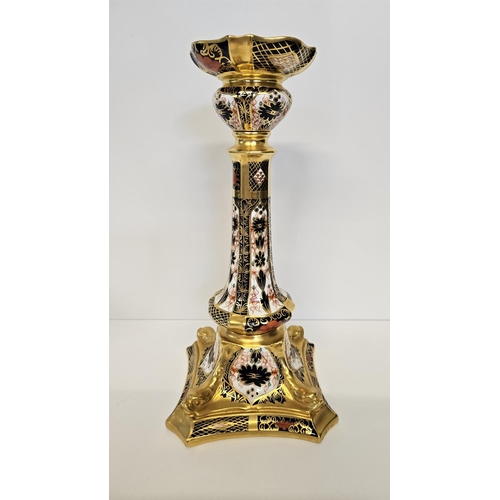 15 - A Pair of Royal Crown Derby Table Candlesticks, on square dolphin bases, decorated in Imari pattern ... 