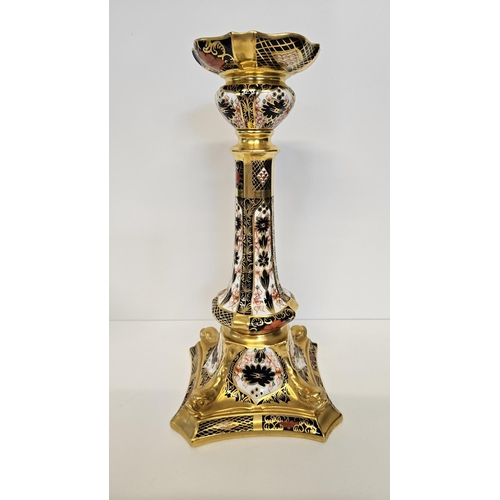 15 - A Pair of Royal Crown Derby Table Candlesticks, on square dolphin bases, decorated in Imari pattern ... 