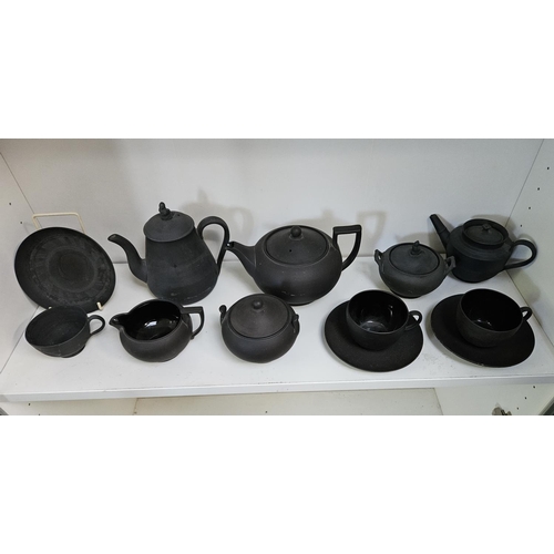 22 - Collection of Wedgwood Black Basalt tableware to include Teapots with covers, Sugar bowls, Cream Jug... 