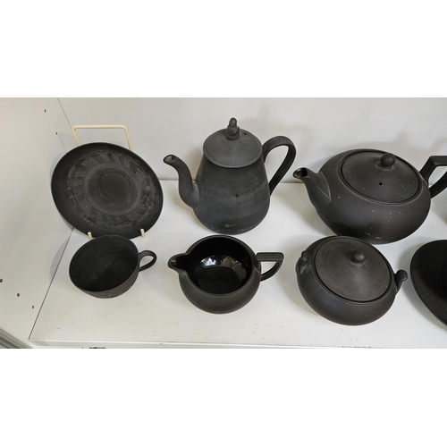 22 - Collection of Wedgwood Black Basalt tableware to include Teapots with covers, Sugar bowls, Cream Jug... 