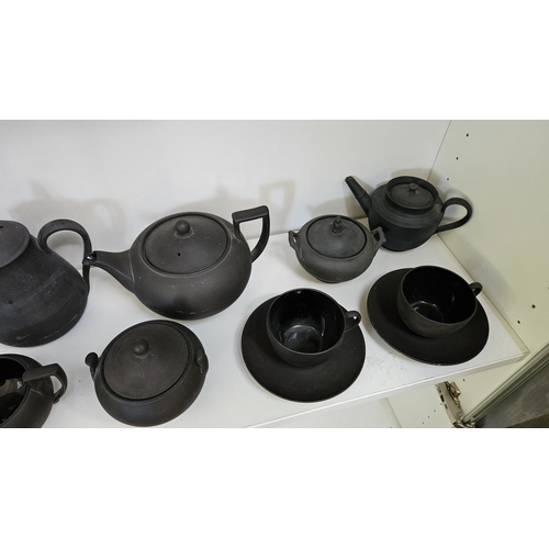 22 - Collection of Wedgwood Black Basalt tableware to include Teapots with covers, Sugar bowls, Cream Jug... 