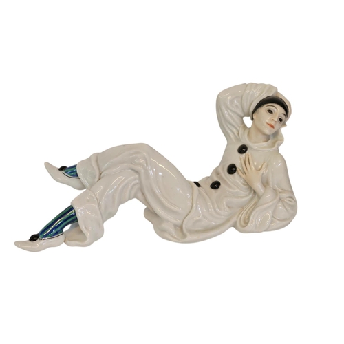 6 - A Rosenthal figure of a Pierrot, designed by Rudolf Greiner, modelled lying down printed and painted... 