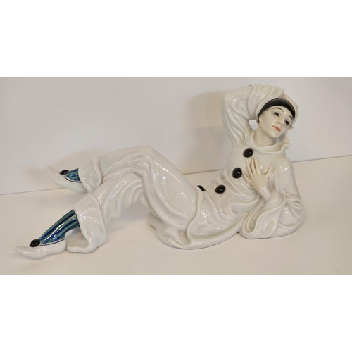 6 - A Rosenthal figure of a Pierrot, designed by Rudolf Greiner, modelled lying down printed and painted... 