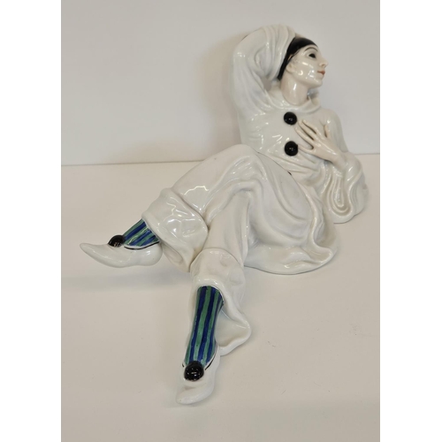 6 - A Rosenthal figure of a Pierrot, designed by Rudolf Greiner, modelled lying down printed and painted... 