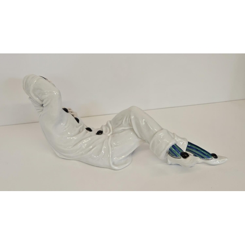 6 - A Rosenthal figure of a Pierrot, designed by Rudolf Greiner, modelled lying down printed and painted... 