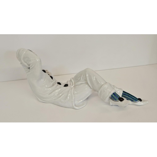 6 - A Rosenthal figure of a Pierrot, designed by Rudolf Greiner, modelled lying down printed and painted... 