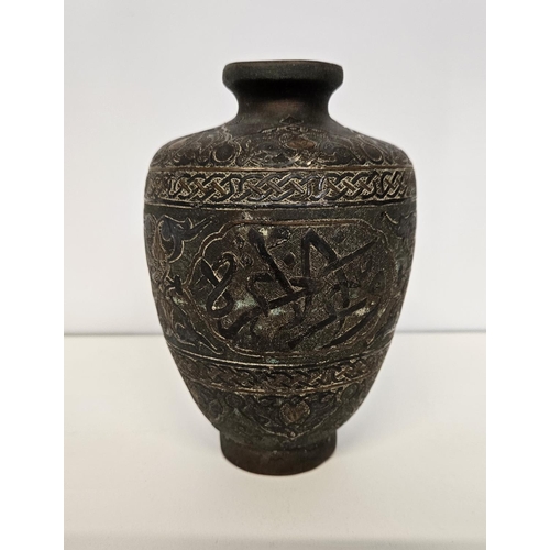 41 - Islamic Style Bronze Calligraphic Vase with Silver Overlay An undated archaistic hollow-cast Baluste... 