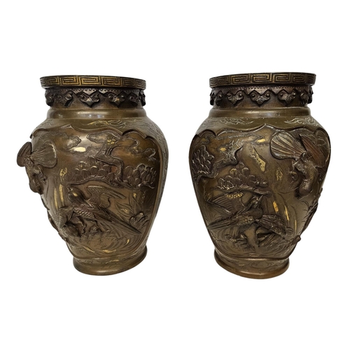 51 - Pair of Japanese Meiji period Bronze parcel glit high relief vases decorated with Storks and rocky o... 