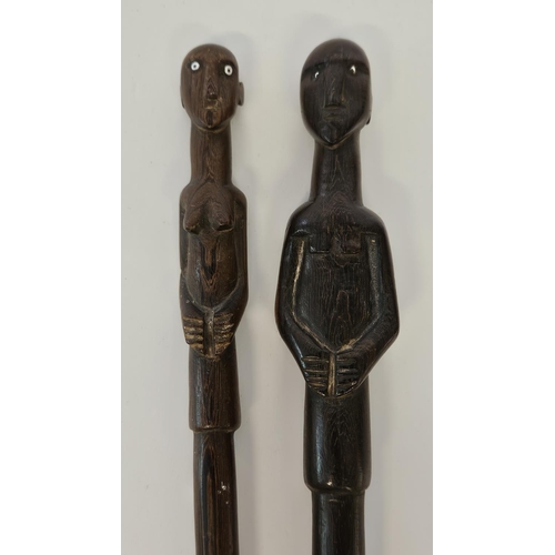 53 - 2 South African Hardwood walking canes the handle carved with a mans head and torso (L 89cm) and sim... 