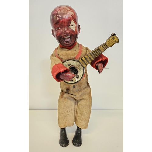 90 - Early 20thC Gunthermann tin plate and clockwork celluloid clockwork celluloid model of a Banjo Playe... 