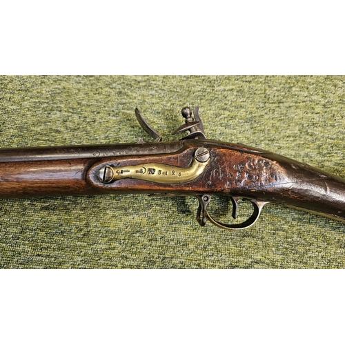 99 - An Early 19th flintlock musket rifle possible East Indian company, the action stamped, the walnut st... 