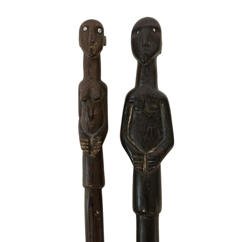 53 - 2 South African Hardwood walking canes the handle carved with a mans head and torso (L 89cm) and sim... 