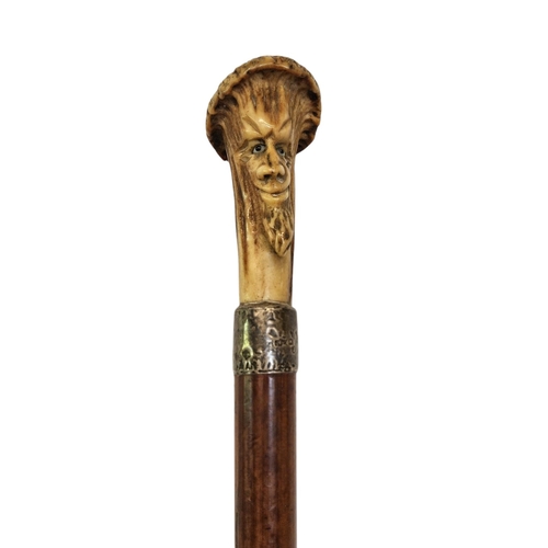 78 - 19thC Antler topped walking Cane with carved bearded face over Silver Collar and tapering fruitwood ... 