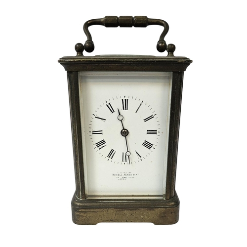 102 - Howell James of London Brass Carriage clock with roman numeral dial, complete with key. 16cm in Heig... 