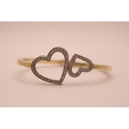 196 - 20thC 9ct Gold Twin Heart Design Diamond set bangle with sprung hinged fitting. 63mm in Diameter. 16... 