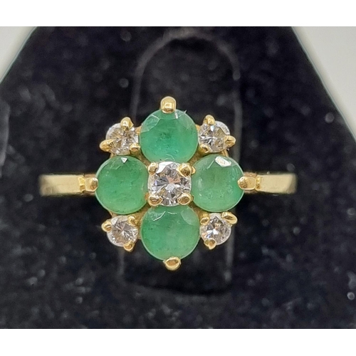 216 - 18ct Gold Diamonds & Green Emeralds Cavendish Ring 3.04gms. Five brilliant cut diamonds central diam... 