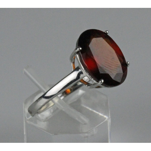 223 - 10ct white gold dress ring, set with large oval faceted Almandine Garnet, weighs 3.5 grams. Ring siz... 