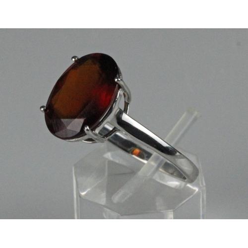 223 - 10ct white gold dress ring, set with large oval faceted Almandine Garnet, weighs 3.5 grams. Ring siz... 